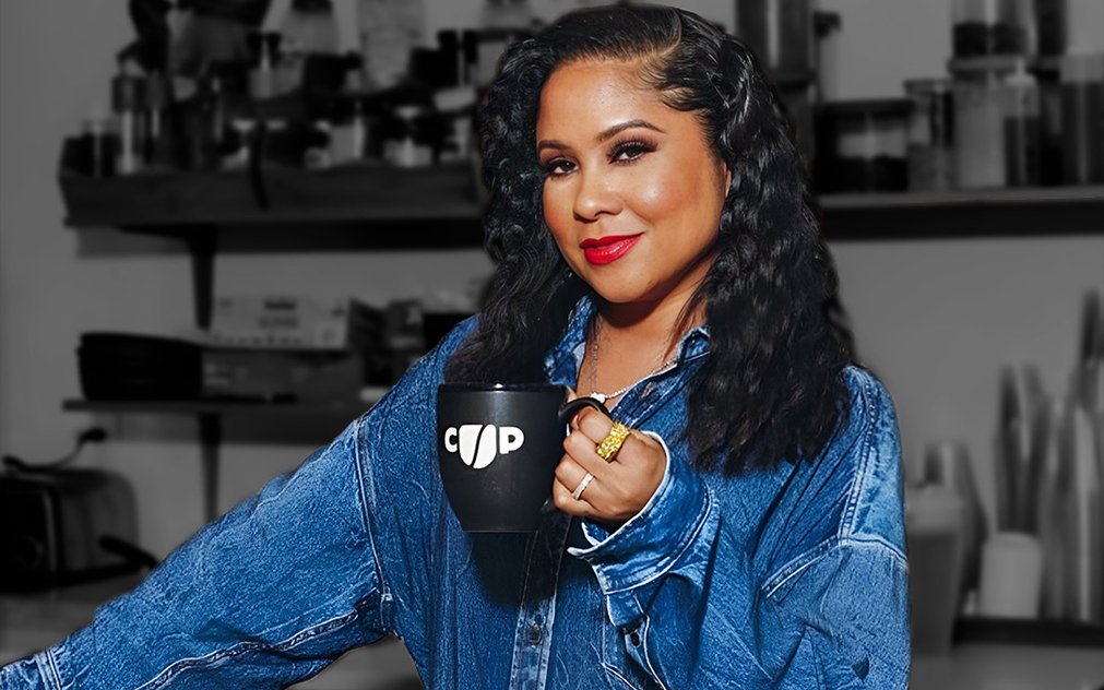 Angela Yee holding a Coffee Uplifts People mug, representing Channing & Company’s brand strategy and culture-led marketing work for CUP.