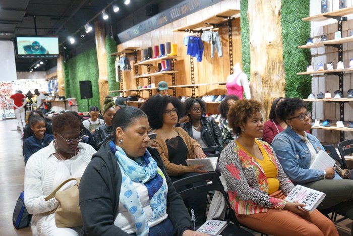 Audience members seated inside WOODstack IVY during an Angela Yee Book Club event in Brooklyn, an early community program that informed the WellRead nonprofit brand strategy.