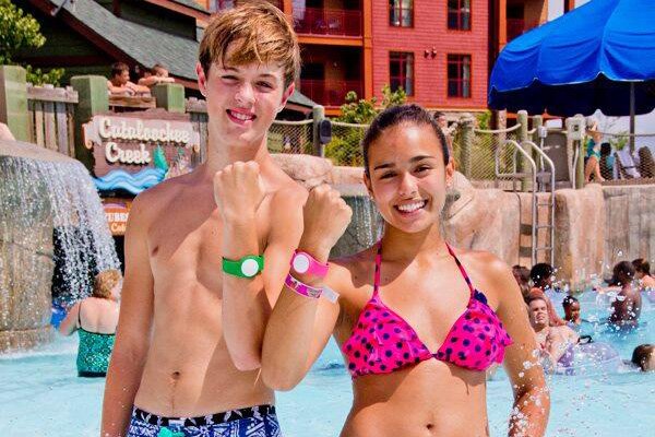 Amusement park guests displaying Action Bracelet wearable photo wristbands.